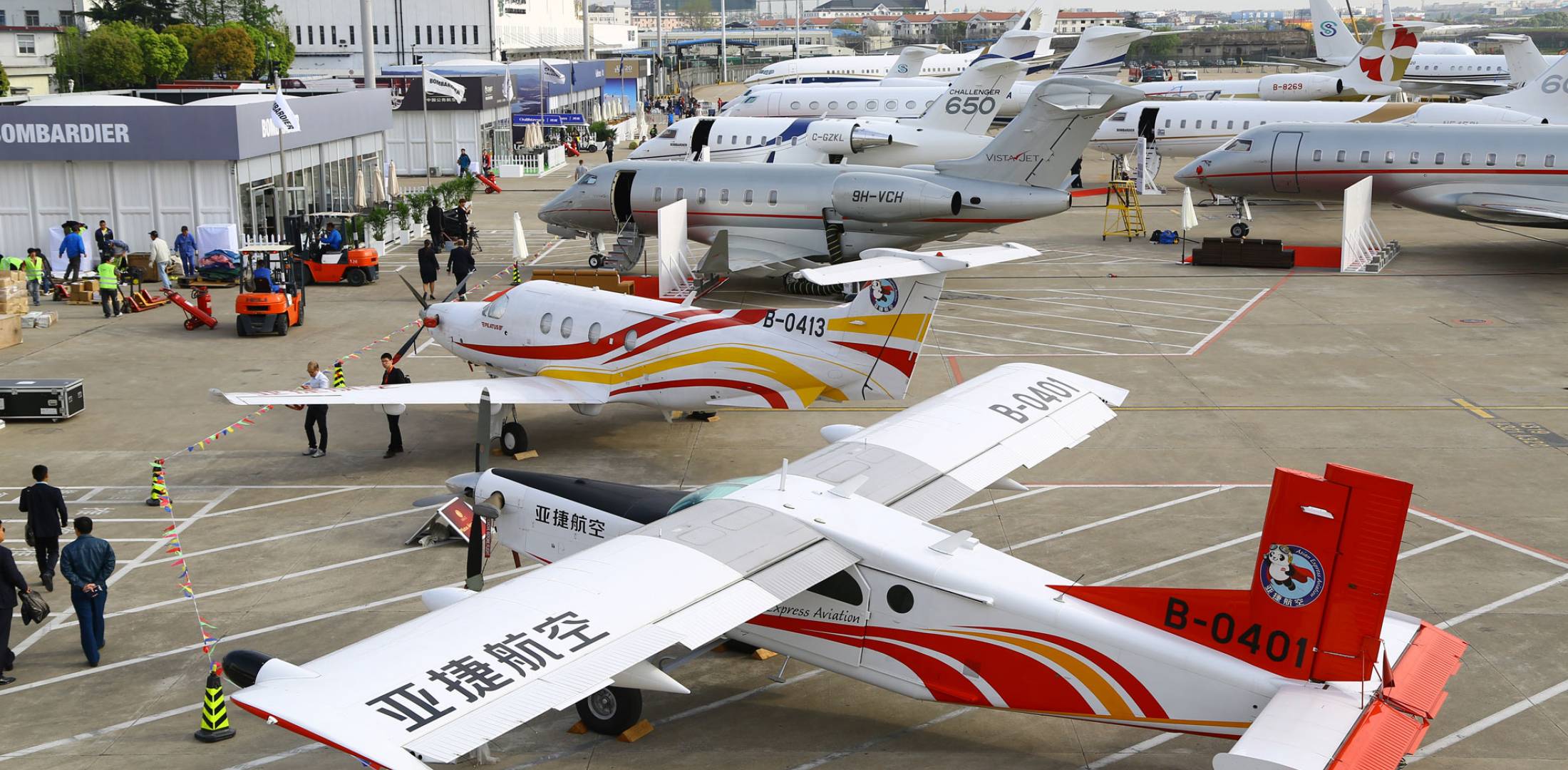 Private planes and attendees on the tarmac at ABACE