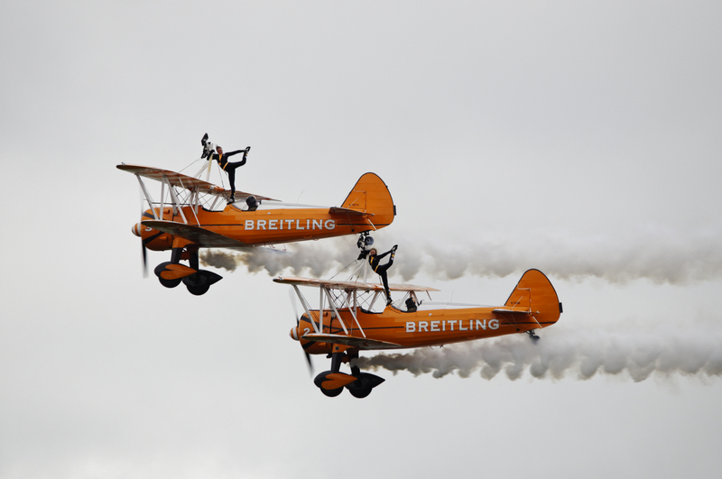 Wing walkers on a plane flying above the Farnborough International Airshow