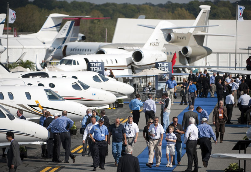 NBAA Business Aviation Regional Forum with attendees and parked private planes.