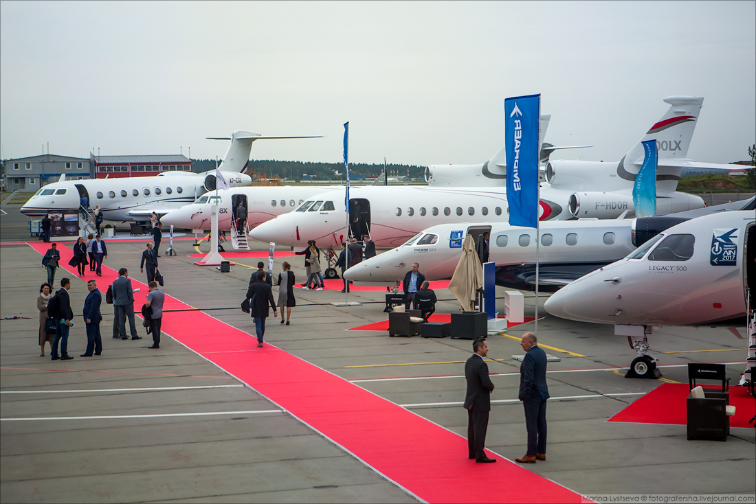 Private jets and event attendees on a tarmac at RUBAE - Russian Business Aviation Exhibition