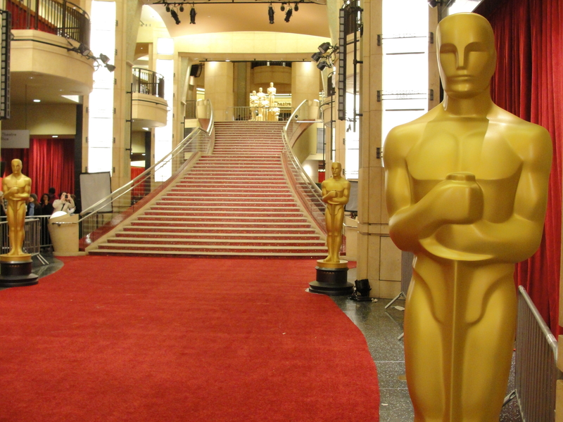 Human-sized gold Oscars statues on the red carpet at the Academy Awards.