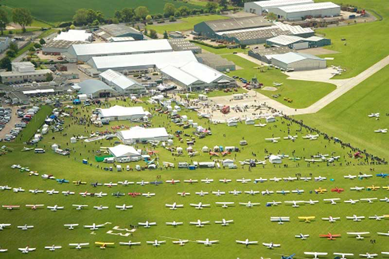 Dozens of small airplanes parked in the fields of Sywell Aerodrome during the AeroExpo UK.