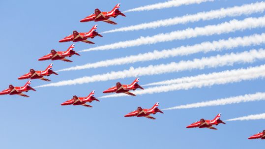 Red Arrows fighter jets flying in formation at the RIAT Royal International Air Tattoo.