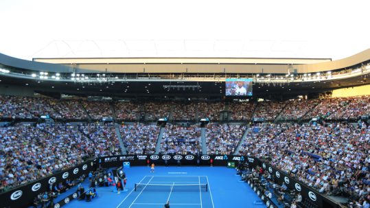 Tennis match in a full stadium at the Australian Open.