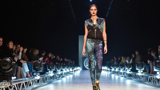 Female model walking the catwalk at Berlin Fashion Week.