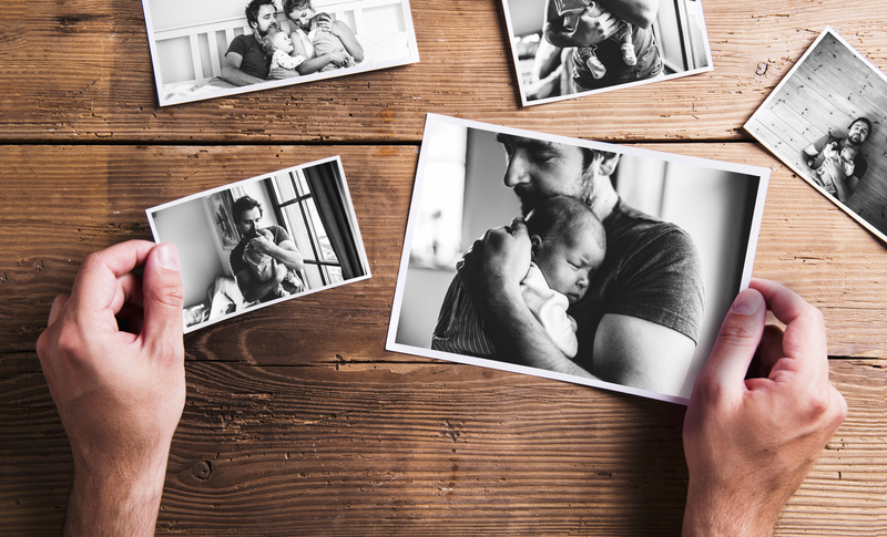 Black and white photographs of a dad holding his baby on Father's Day.