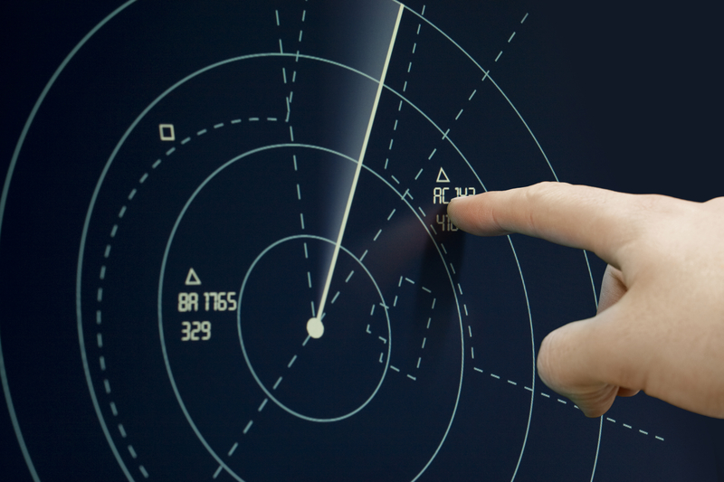 Finger pointing at a blip on the radar on International Day of the Air Traffic Controller.