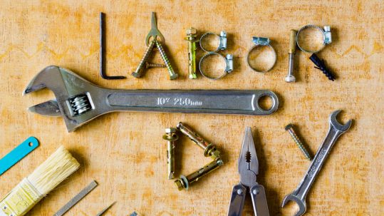 Labor Day spelled out in tools on a table.