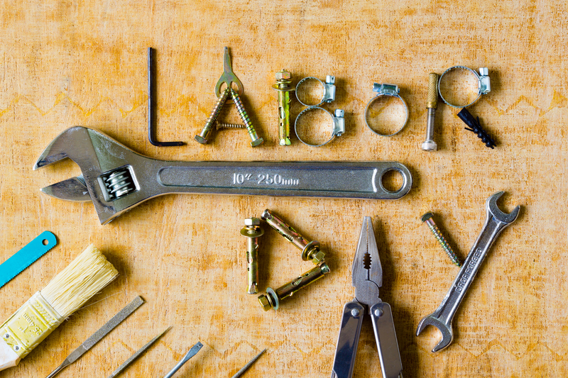 Labor Day spelled out in tools on a table.