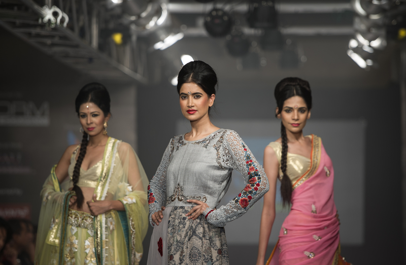 Three female models posing on the runway at Lakme Fashion Week.