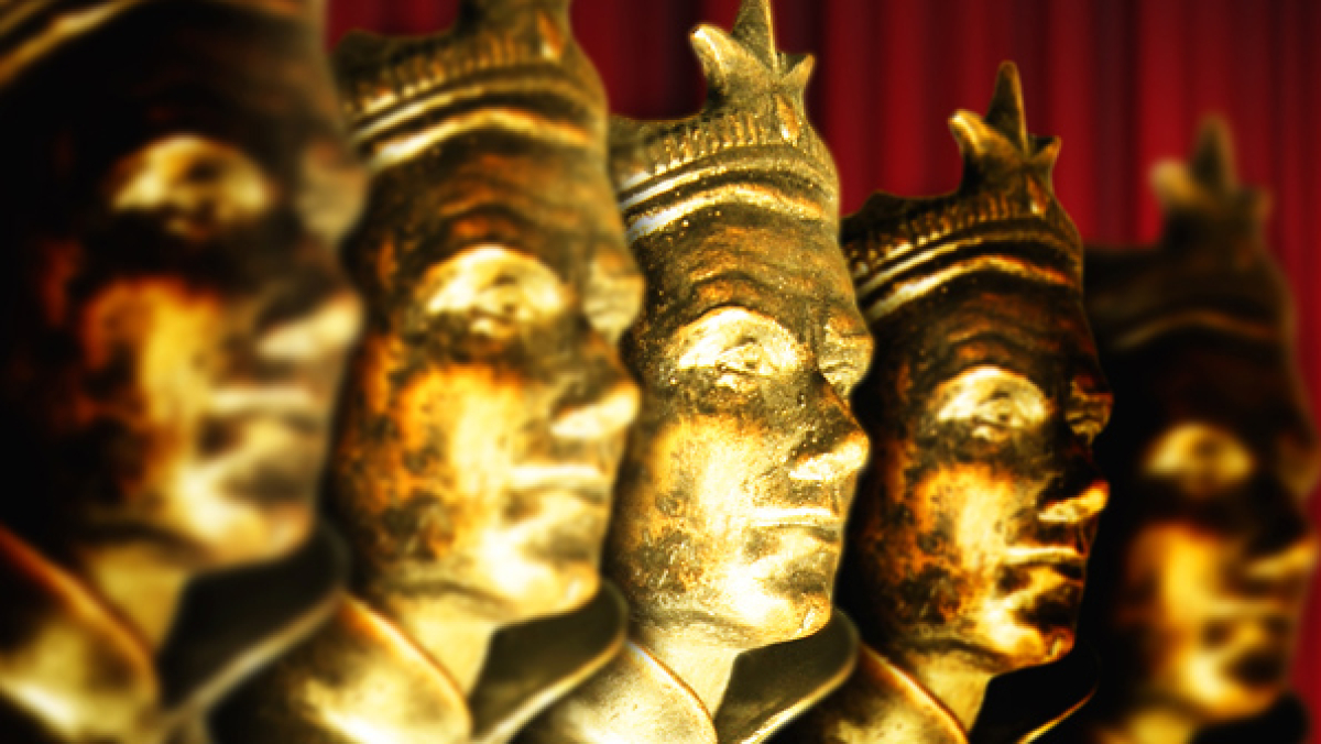 A row of five golden statuette faces at the Laurence Olivier Awards.