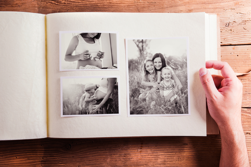 Photo album with black and white photos of mom with children on Mother's Day.