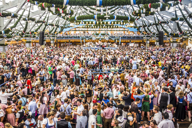 Hundreds of people drinking in a beer garden at Munich Oktoberfest.