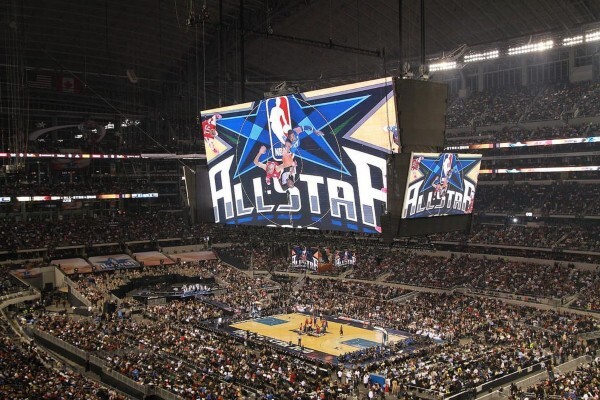 Giant scoreboard above the basketball court and fans at the NBA All-Star-Game