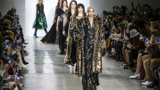 Female models walking the catwalk at New York Fashion Week.