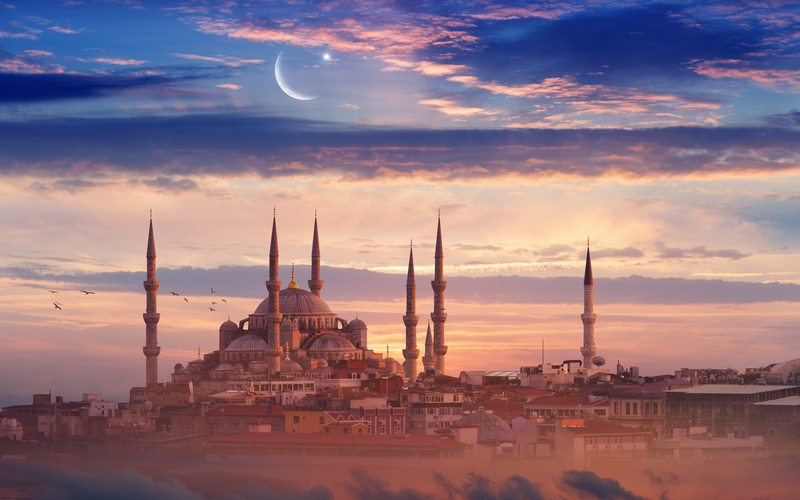 Great mosque and minarets at sunset during Ramadan.
