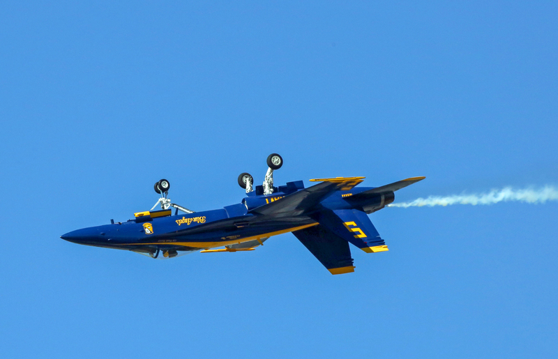 Blue Angels fighter jet flying upside down at the Sun n Fun Aerospace Expo.