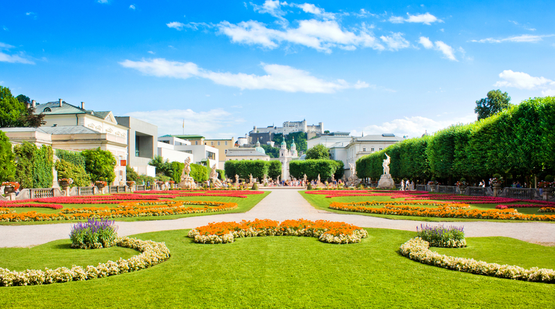 Garden with green lawn and red flowers at the Salzburg Festival.