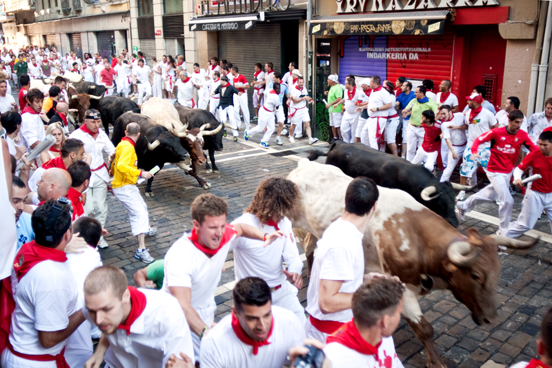 People participating in the Running of the Bulls at the San Fermin Festival