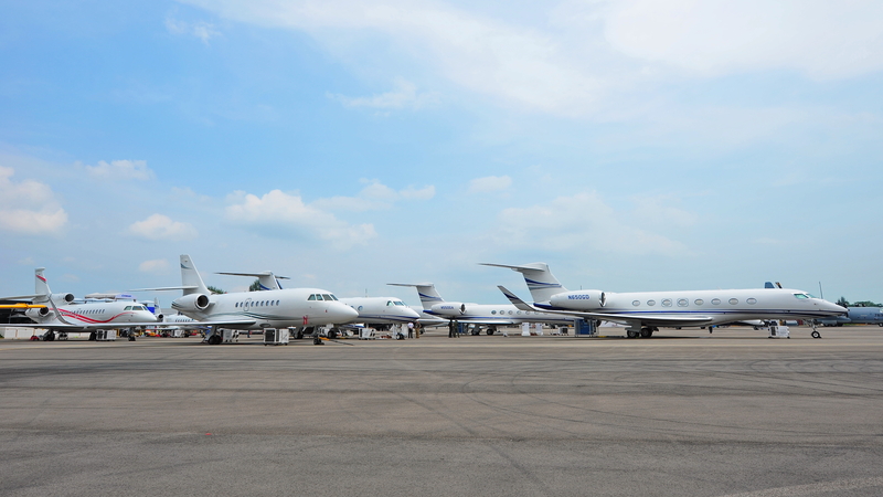 Multiple private jets parked on the tarmac at the Singapore Airshow.