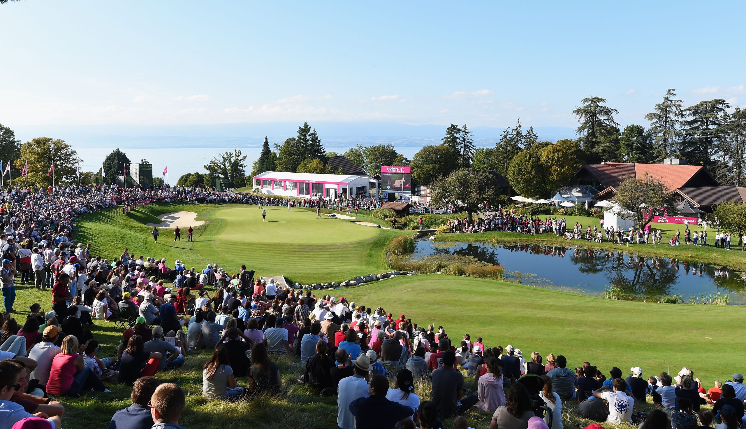 Many spectators surrounding the golf course green and fairway at The Evian Championship.