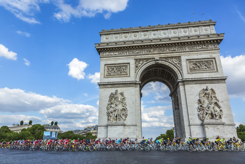 Cyclists riding in front of the Arc de Triomphe during the Tour de France.