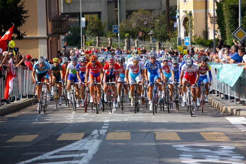 A pack of riders competing in a road race at the UCI Cycling World Championships