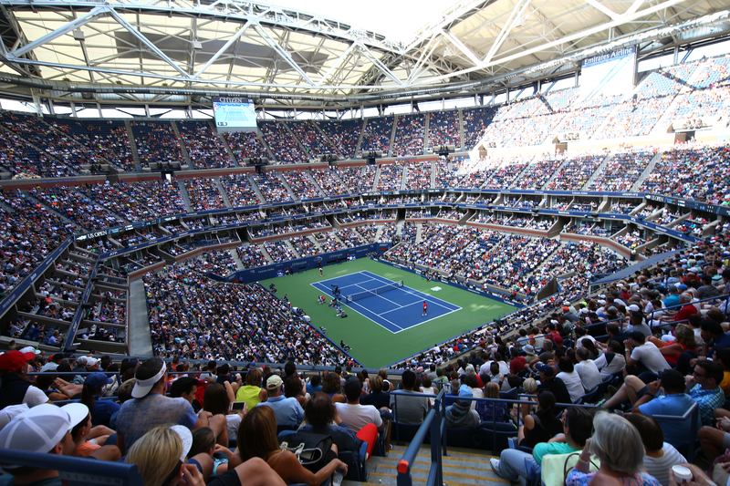 Full stadium watching a tennis match at the US Open Tennis Championships.