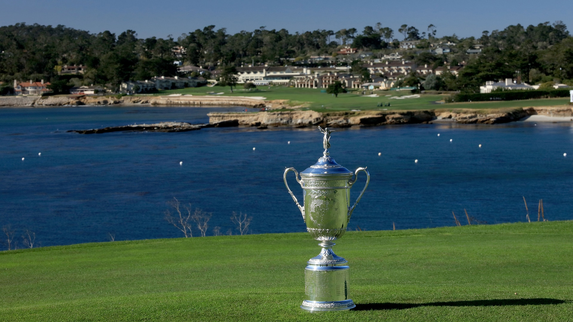 U.S. Women's Open trophy overlooking a pond at the golf course.