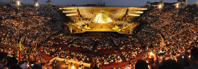 Panoramic view of the audience and stage at the outdoor Verona Opera Festival.