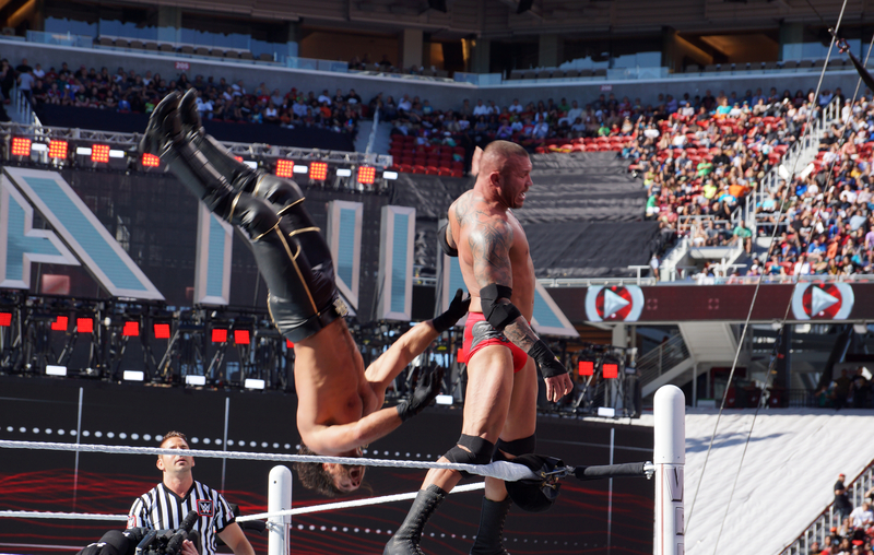 One wrestler flipping another at WrestleMania.