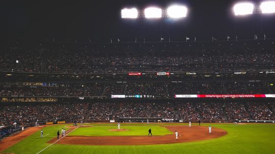 Night baseball game in a full stadium at the MLB World Series.