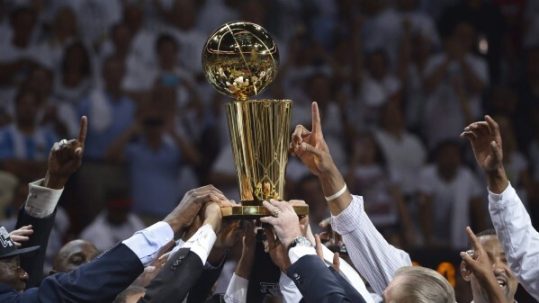 Team raising up the NBA Finals trophy.