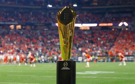 CFP trophy in the foreground as two football teams compete at the College Football National Championship Game.