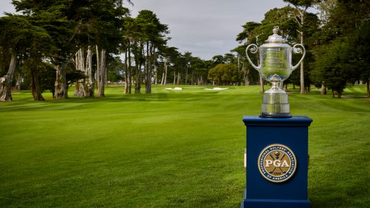 PGA Championship trophy on a beautiful green golf fairway.