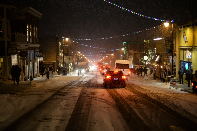 Snow covered street in Park City Utah at night during the Sundance Film Festival.