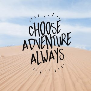 Inspirational quote on a sand dune background telling you to 'Choose Adventure Always'