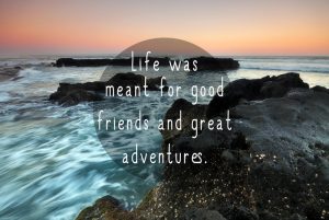 Ocean sunset on a rocky beach with Inspirational Adventure Quotes - 'Life Was Meant For Good Friends and Great Adventures'
