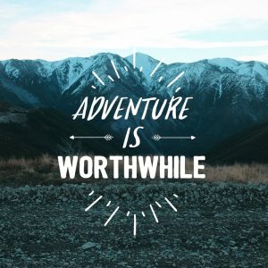 Inspirational quote 'Adventure is worthwhile.' on a snow-capped Mountain background.