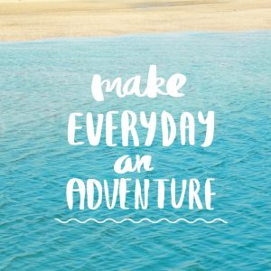 'Make everyday an Adventure' quote on blurred beach and seascape background