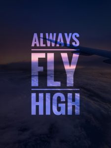 Motivational quote on sunset background with airplane wing above the clouds.
