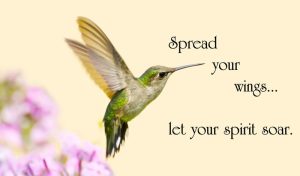 Beautiful ruby throated hummingbird hovering in a garden next to the best flying quotes 'Spread your wings... let your spirit soar.'