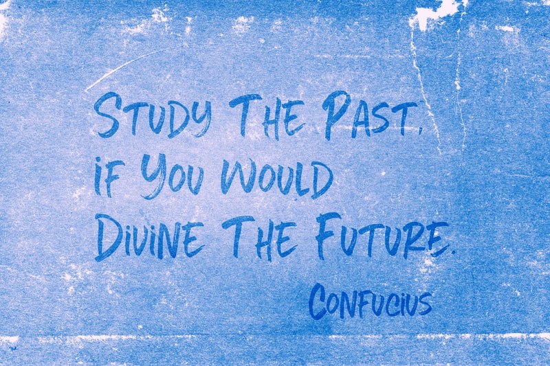 'Study the past, if you would divine the future' - ancient Chinese philosopher Confucius quote about the future printed on grunge blue paper.