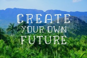 'Create your own future' quote with a tropical jungle mountain background on a pretty day.