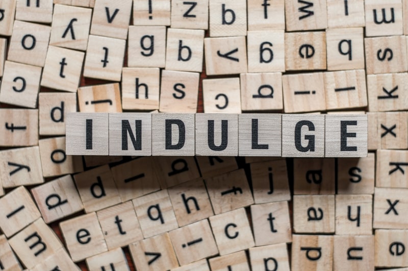 The word INDULGE on building blocks concept to represent the best luxury quotes.