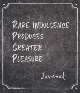 Framed chalkboard with the words 'Rare indulgence produces greater pleasure' by ancient Roman poet Juvenal is one of the best luxury quotes.