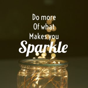 Inspirational luxury quote 'Do more of what makes you sparkle' on lights in the bottle background