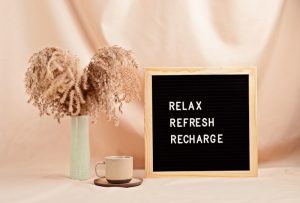 'Relax, refresh, recharge' motivational relaxation quote on a letter board.