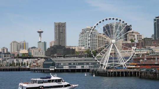 Seattle skyline with Space Needle and Large Ferris Wheel and Ferry Boat