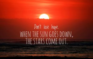 Best space quotes - 'Do not lose hope. When the sun goes down, the stars come out.' on blurry orange sunset background over the sea horizon.